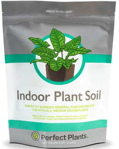 A close up of a bag of Perfect Plants Indoor Plant Soil isolated on a white background.