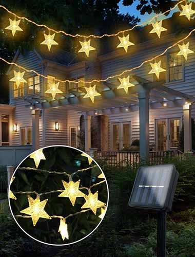 A close up of star-shaped LED fairy lights out in the garden.