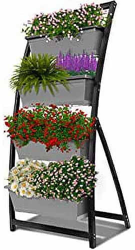 A close up of a raised vertical garden bed with rectangular planters filled with a variety of different flowers isolated on a white background.