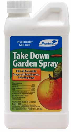 A close up of a bottle of Monterey Take Down Garden spray isolated on a white background.