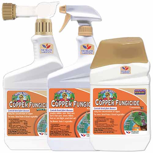 A close up of three bottles of copper fungicide isolated on a white background.