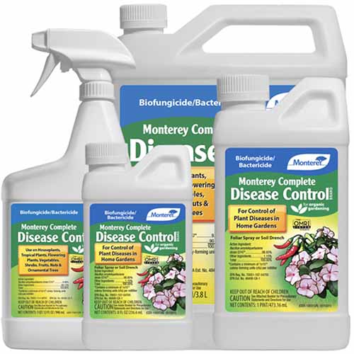 A close up of different sized bottles of Monterey Complete Disease Control isolated on a white background.