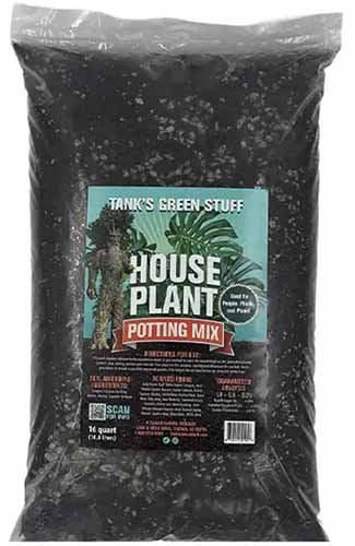 A close up of a bag of Tank's Green Stuff Houseplant potting mix isolated on a white background.